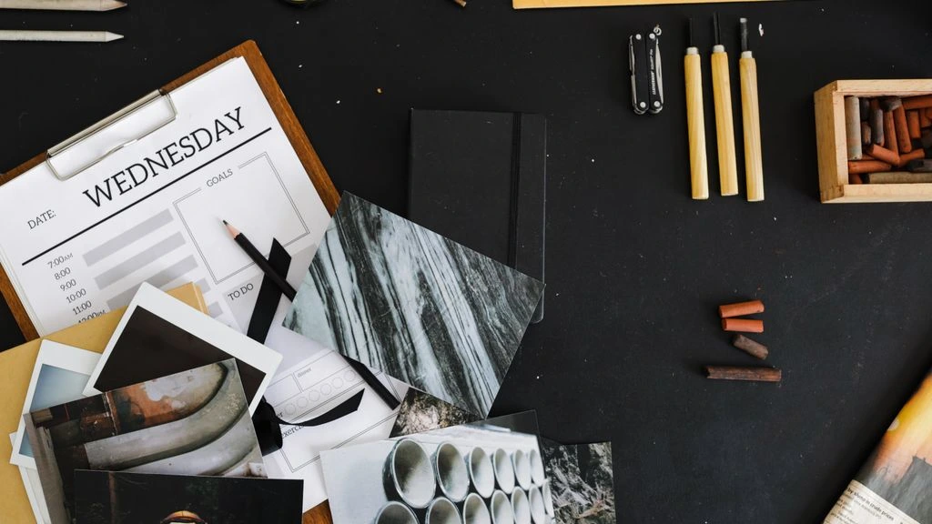 A founder's desk lit by a single warm lamp, notebook open mid-thought.
